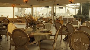 A restaurant with outdoor seating, wicker chairs, and tables set with glassware and decorative plants. - Lale Boutique Hotel (Sapanca)