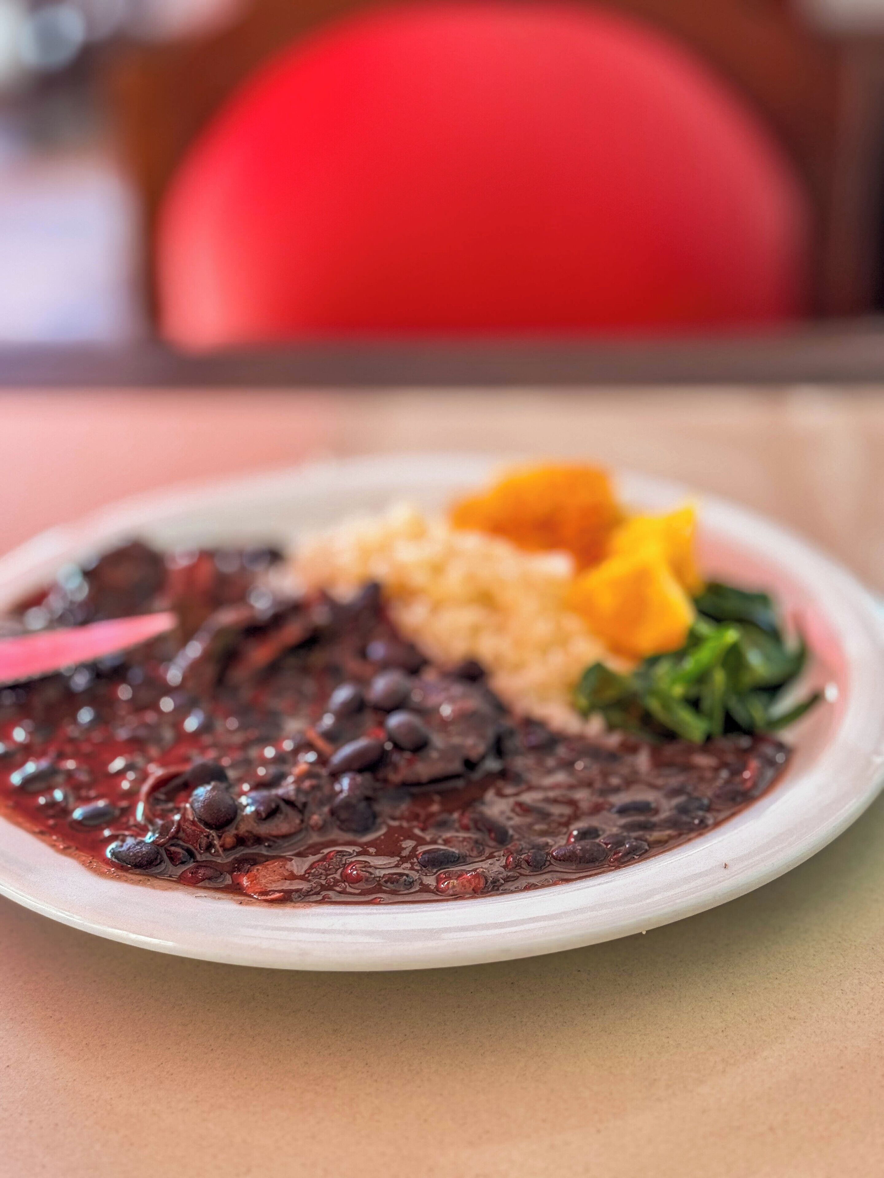 A plate of food with beans, rice, and vegetables.