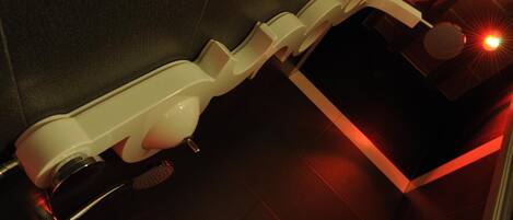 A modern bathroom with a white toilet, a bidet, and a heated floor.