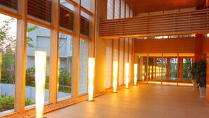 A spacious indoor corridor with large windows, wooden slats, and illuminated columns. - Mars Garden Wood Gotemba (Gotemba)