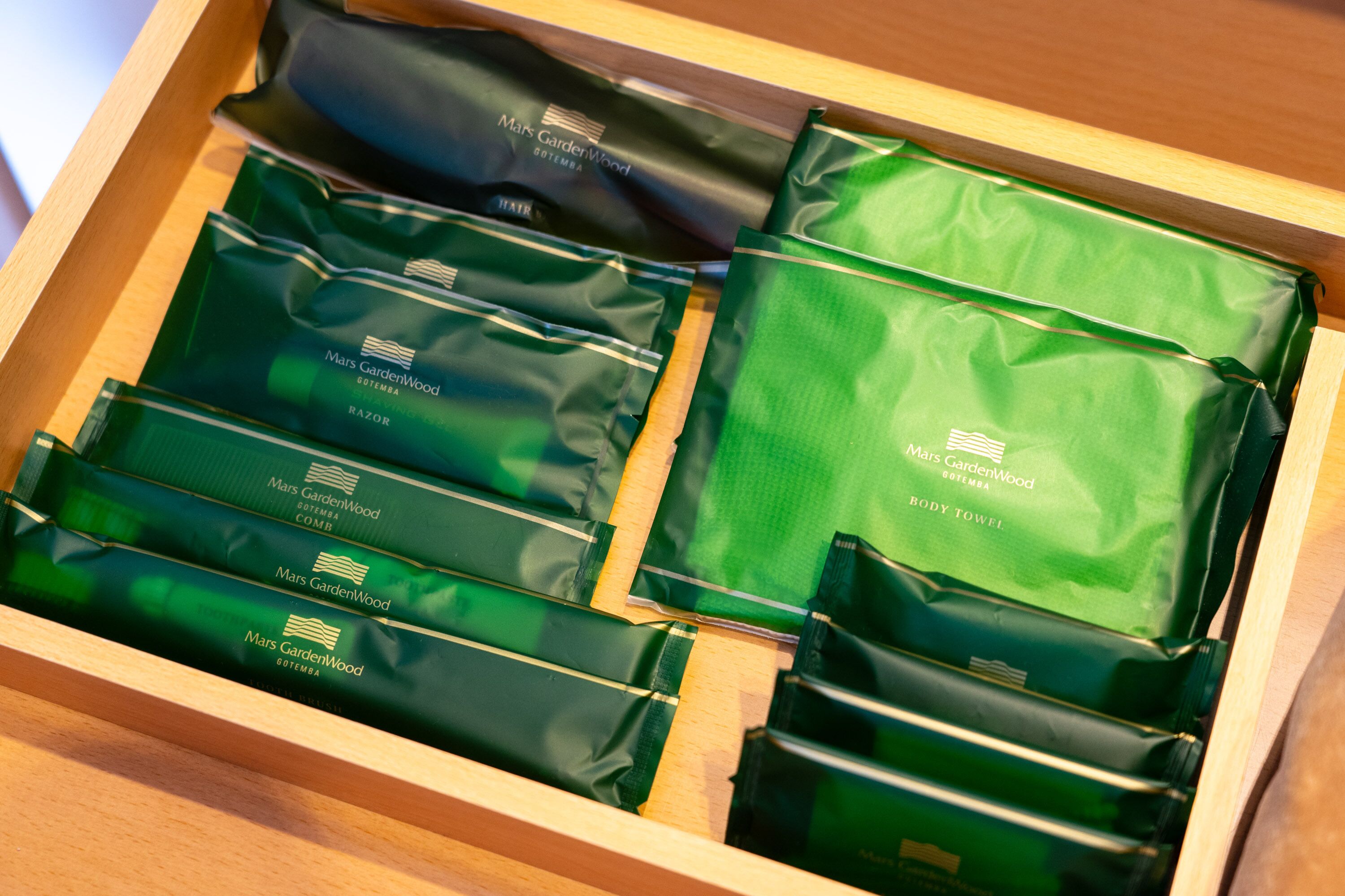 A drawer containing neatly organized green and black bags labeled 'Mars GardenWood'.