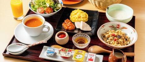 A tray with various breakfast items including eggs, bread, and a bowl of cereal.