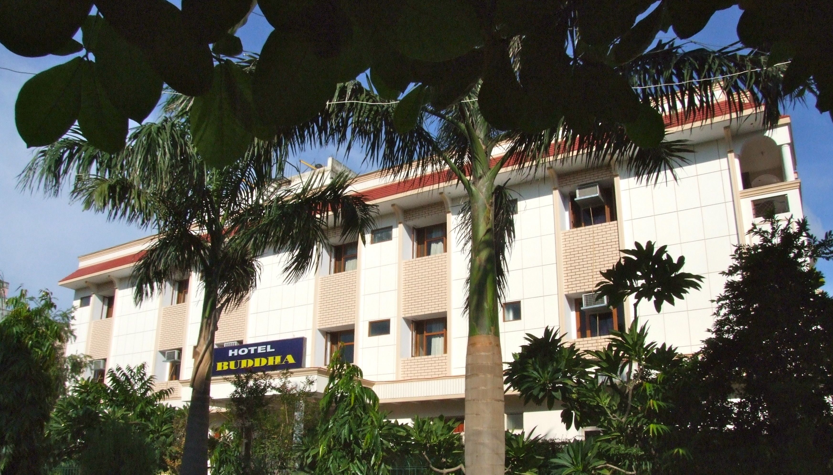 A multi-story building with a sign reading "HOTEL BUDDHA."