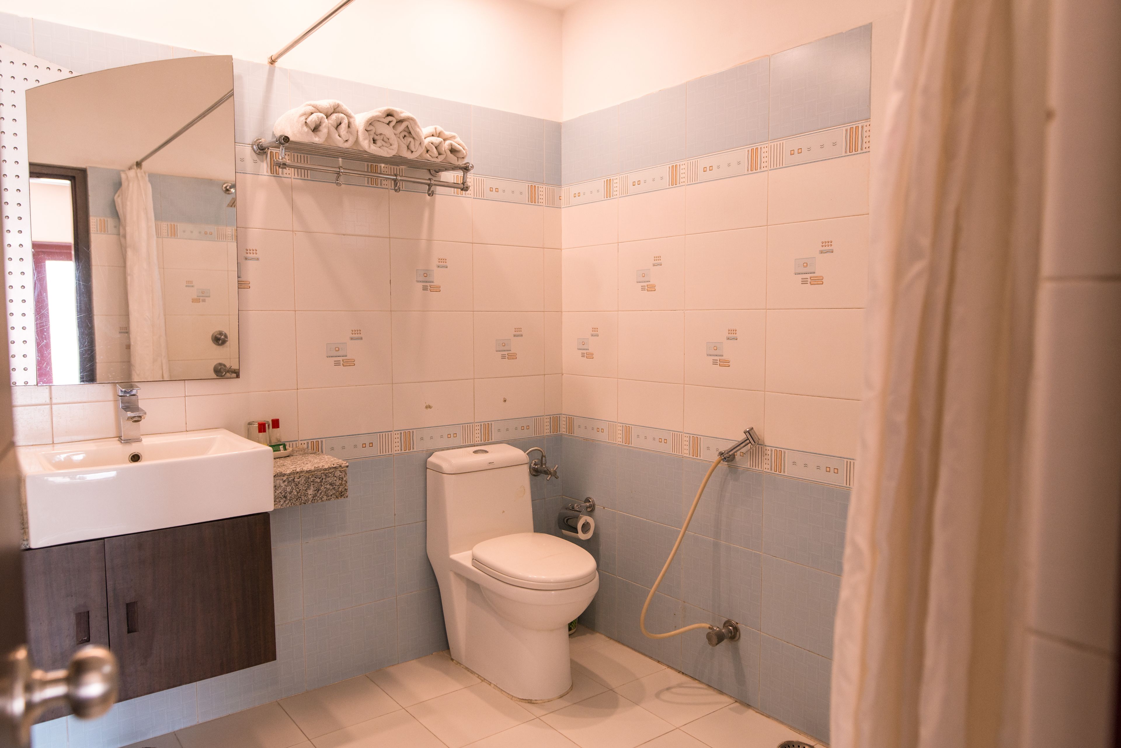 A bathroom with a toilet, sink, and shower.