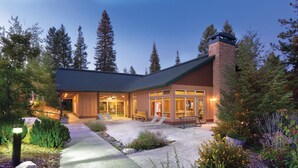 A lodge with a patio, outdoor seating, and a stone chimney. - WorldMark McCall (McCall)