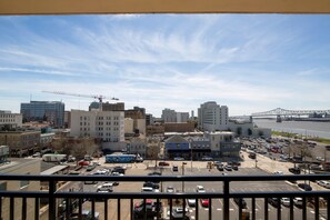 A cityscape with a bridge in the background, a parking lot, and various buildings.
