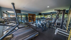 A gym with treadmills, elliptical machines, and weight equipment. - Dolphin Suites (Kampala)
