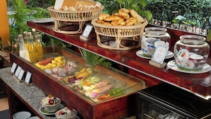 A buffet with bread, pastries, and a variety of fruits and vegetables. - Home Indochine D'angkor (Siem Reap)
