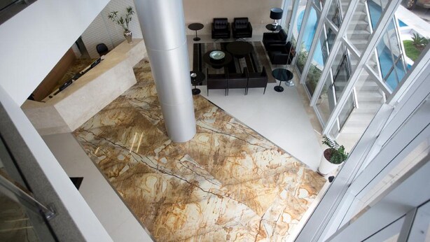 A modern interior with a marble floor, black furniture, and large windows. - Days Inn Linhares (Linhares)