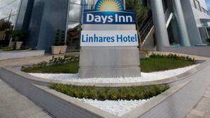 A modern hotel building with a prominent Days Inn sign and a Linhares Hotel sign. - Days Inn Linhares (Linhares)