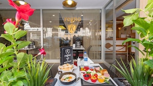 A table with a variety of dishes and a sign for 'regno cafe & restaurant'. - Regno Hotel (Istanbul)