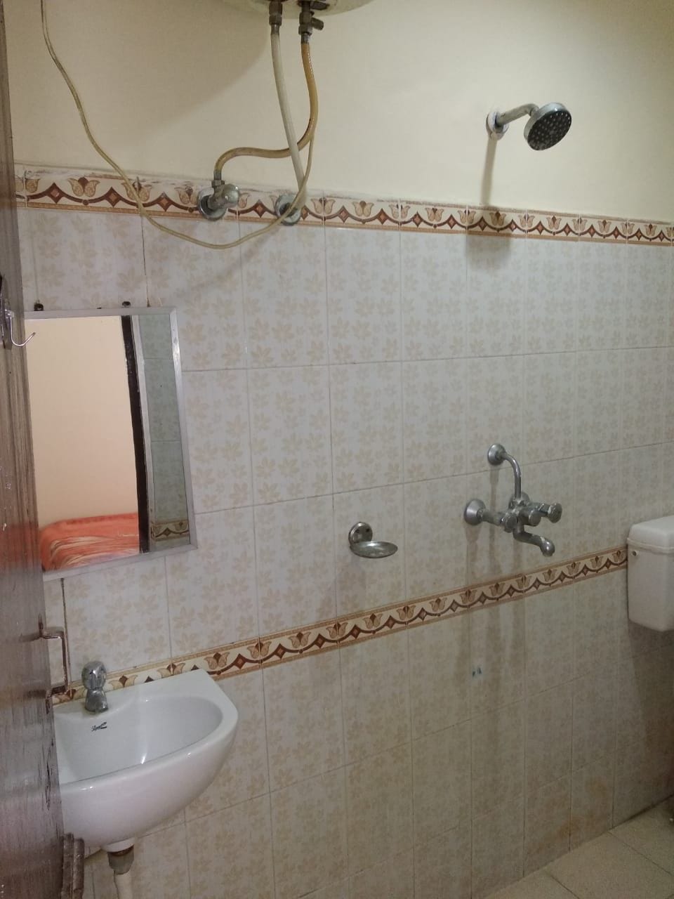A bathroom with a sink, a shower, and a toilet.