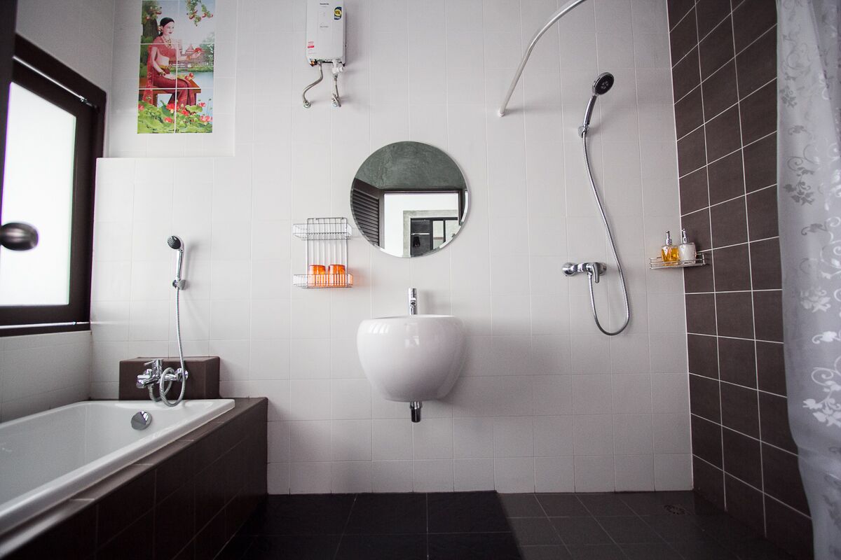 A modern bathroom with a bathtub, a sink, a shower, and a toilet.