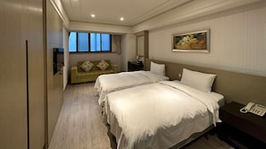 A hotel room with two beds, a sofa, a painting, and a telephone on a nightstand. - LinkWorld Hotel Taipei (Taipei)