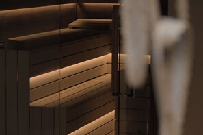 A modern interior with horizontal wooden panels and recessed lighting. - City Solei Boutique Hotel (Poznan)