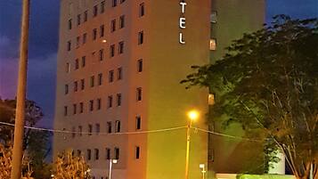 A multi-story hotel with a prominent 'HOTEL' sign on the facade.