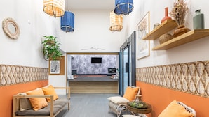 A modern hotel lobby with a sofa, chairs, a small table, and a reception desk. - Appart'City Classic Marseille Euromed (Marseille)