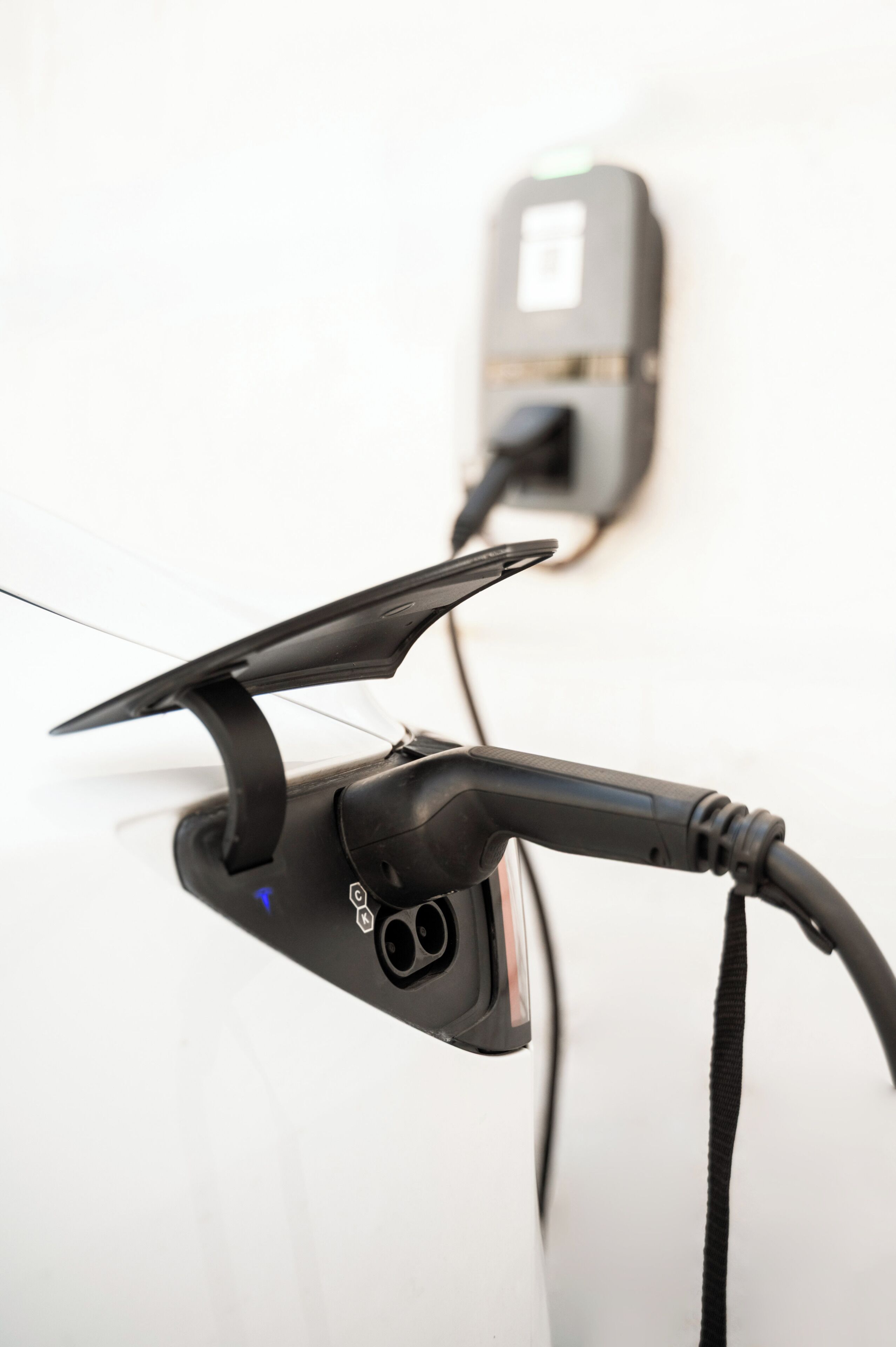 A charging station with a cable connected to a vehicle.