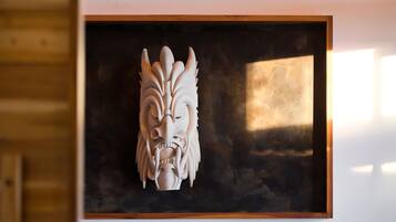 A framed sculpture of a stylized animal head.