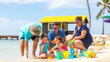 On the beach, white sand, sun-loungers, beach umbrellas