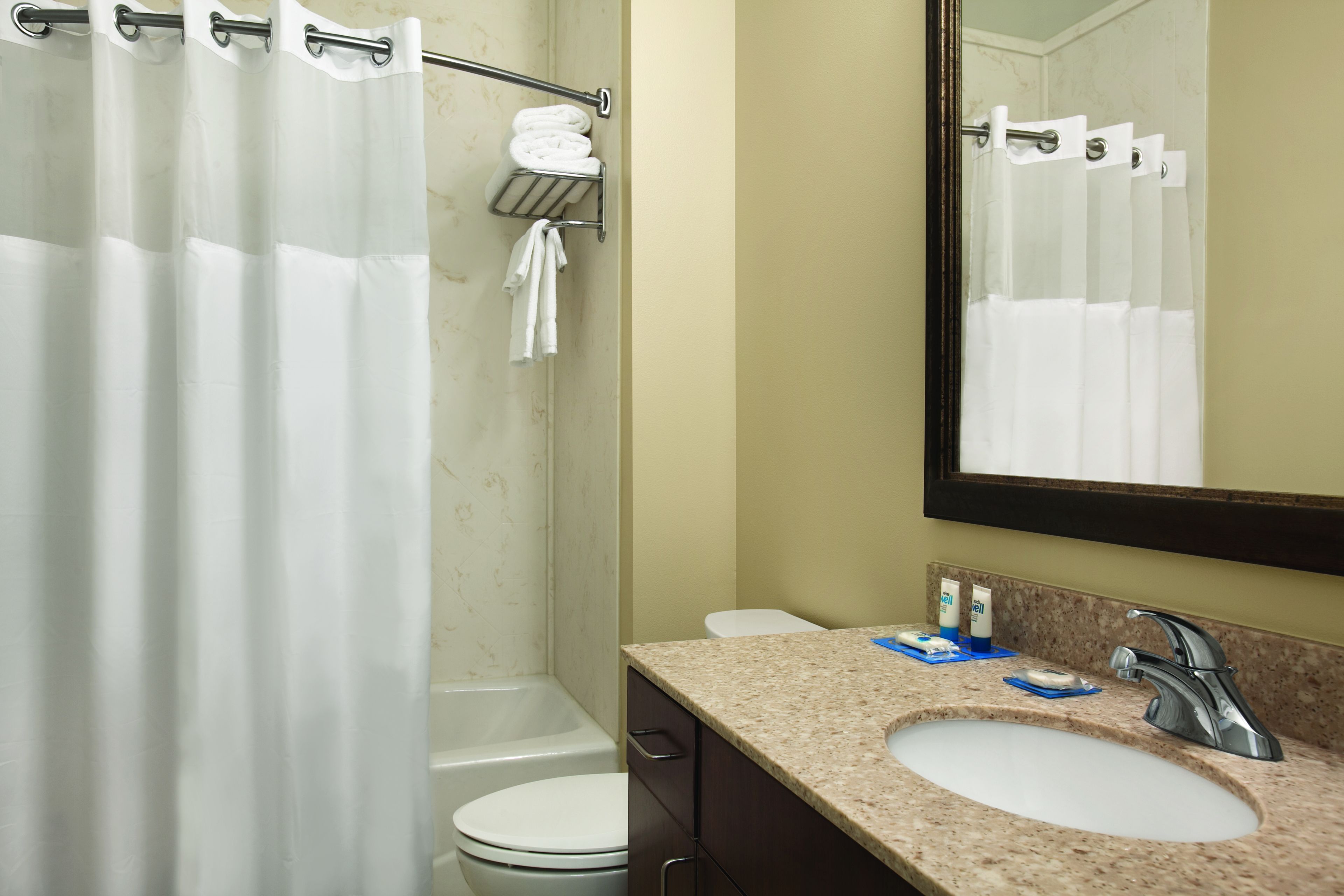 combined shower/bathtub, designer toiletries, hair dryer, towels