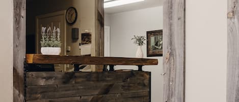 A reception area with a wooden reception desk, a clock on the wall, and a welcome sign.