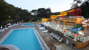 Een binnenzwembad, 8 buitenzwembaden en parasols bij het zwembad