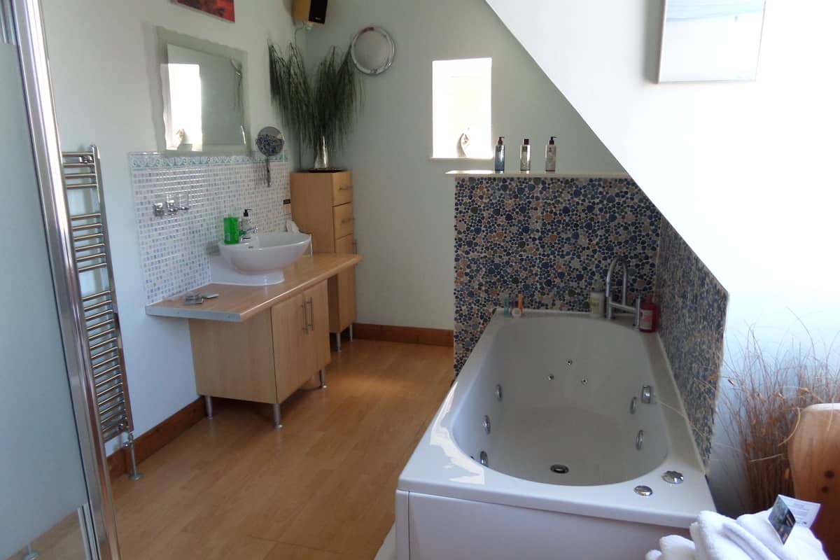 A modern bathroom with a freestanding bathtub, a sink, and a vanity.