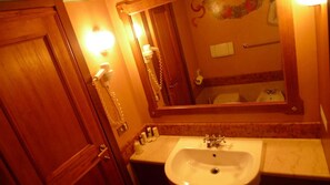 Bathroom features a sink, mirror, and towel rack.