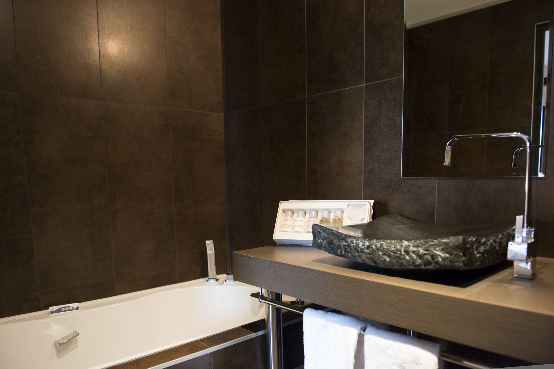 designer toiletries, hair dryer, towels