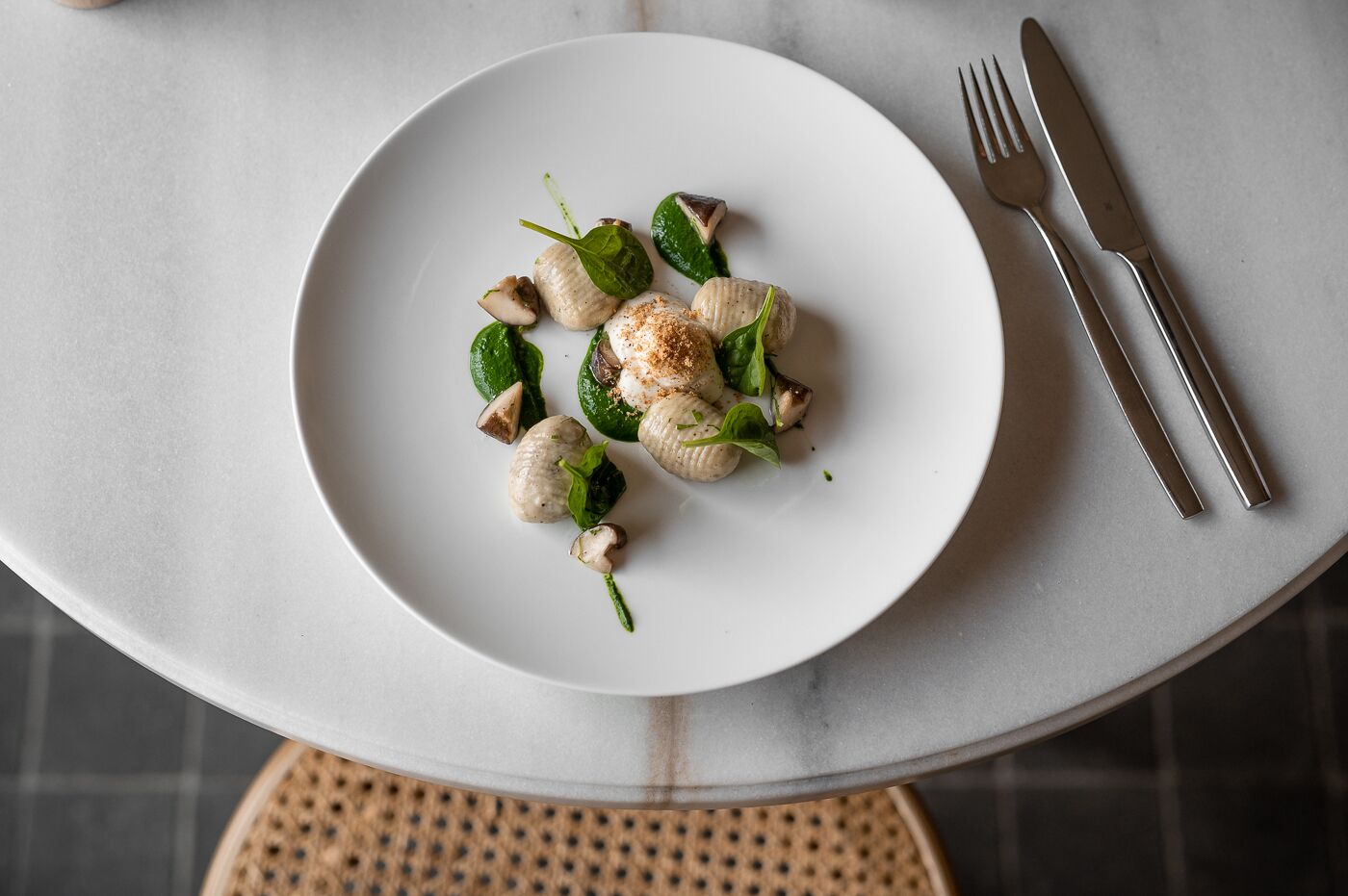 A white plate with food on a table.