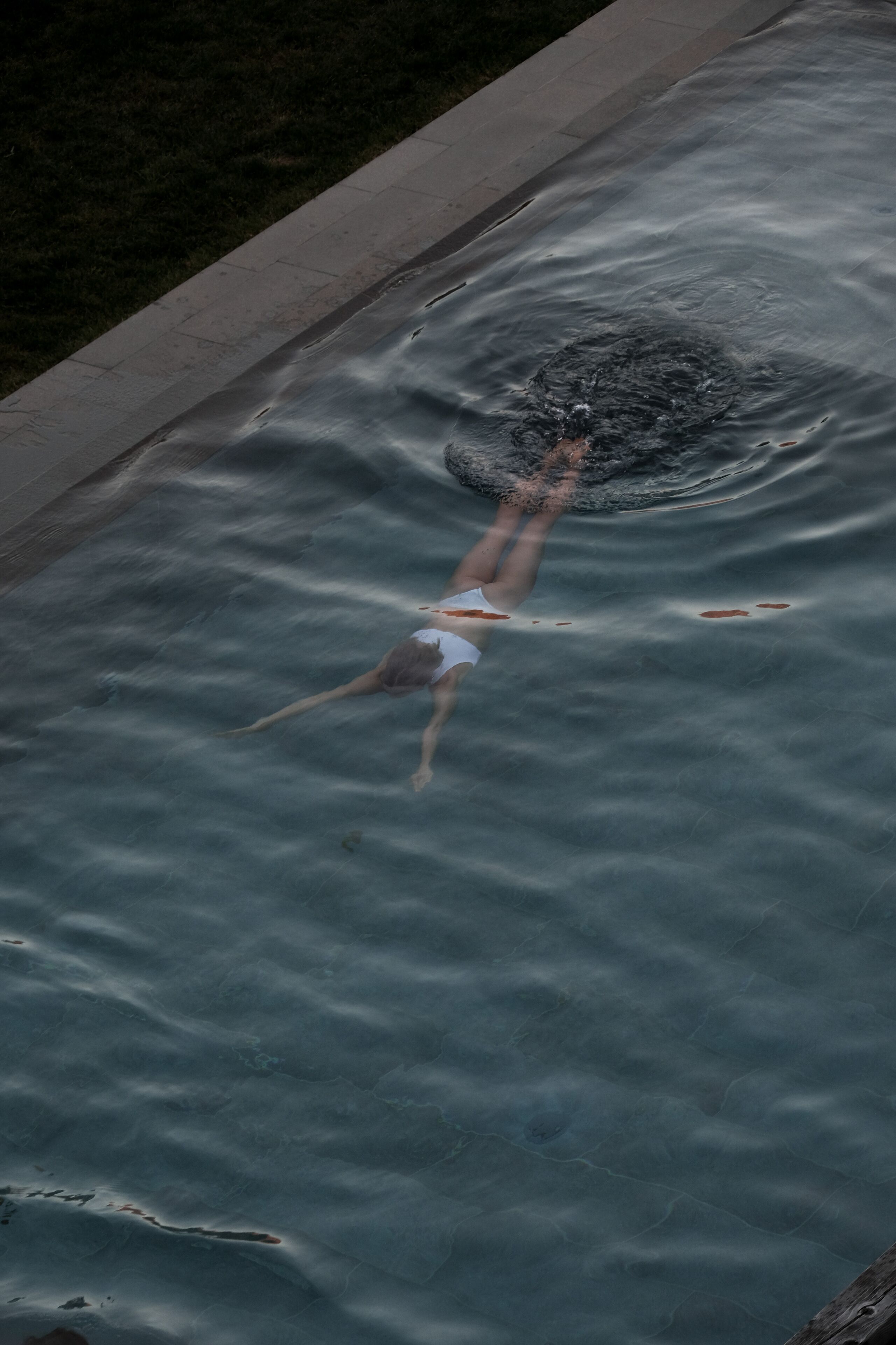 A person swimming in a pool.
