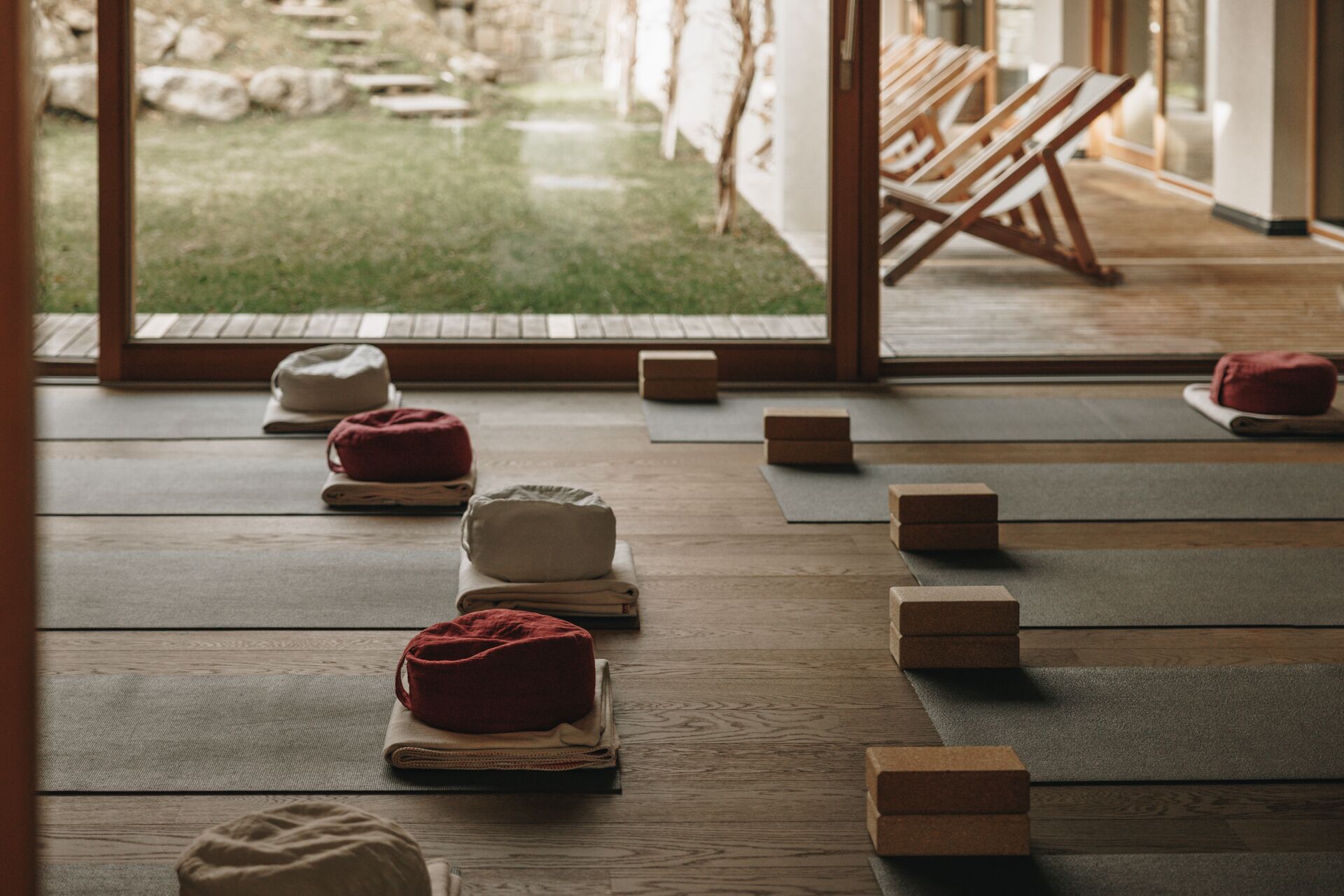 A room with tatami mats, a low wooden table, and cushions.