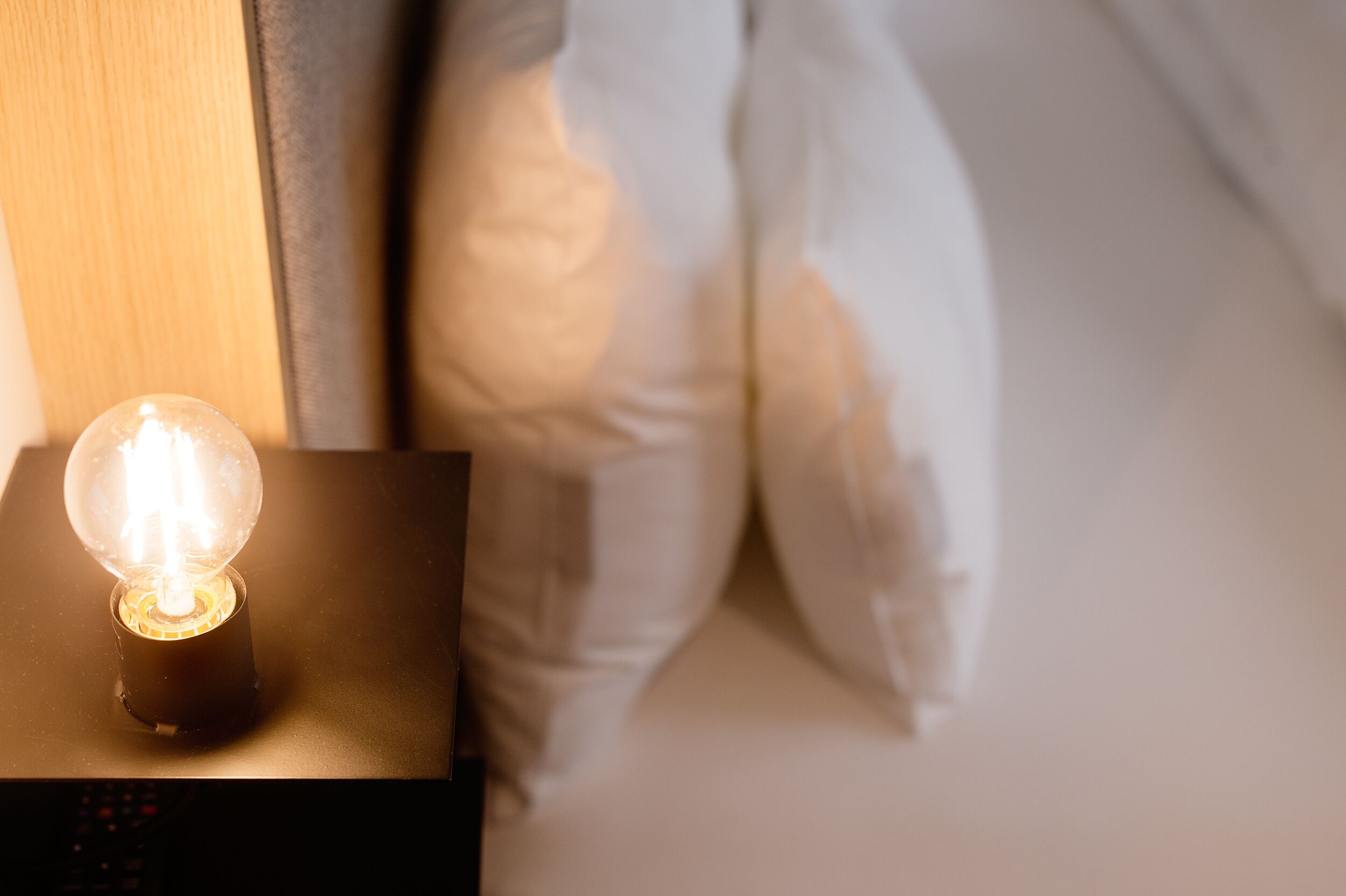 A bedside lamp on a nightstand.