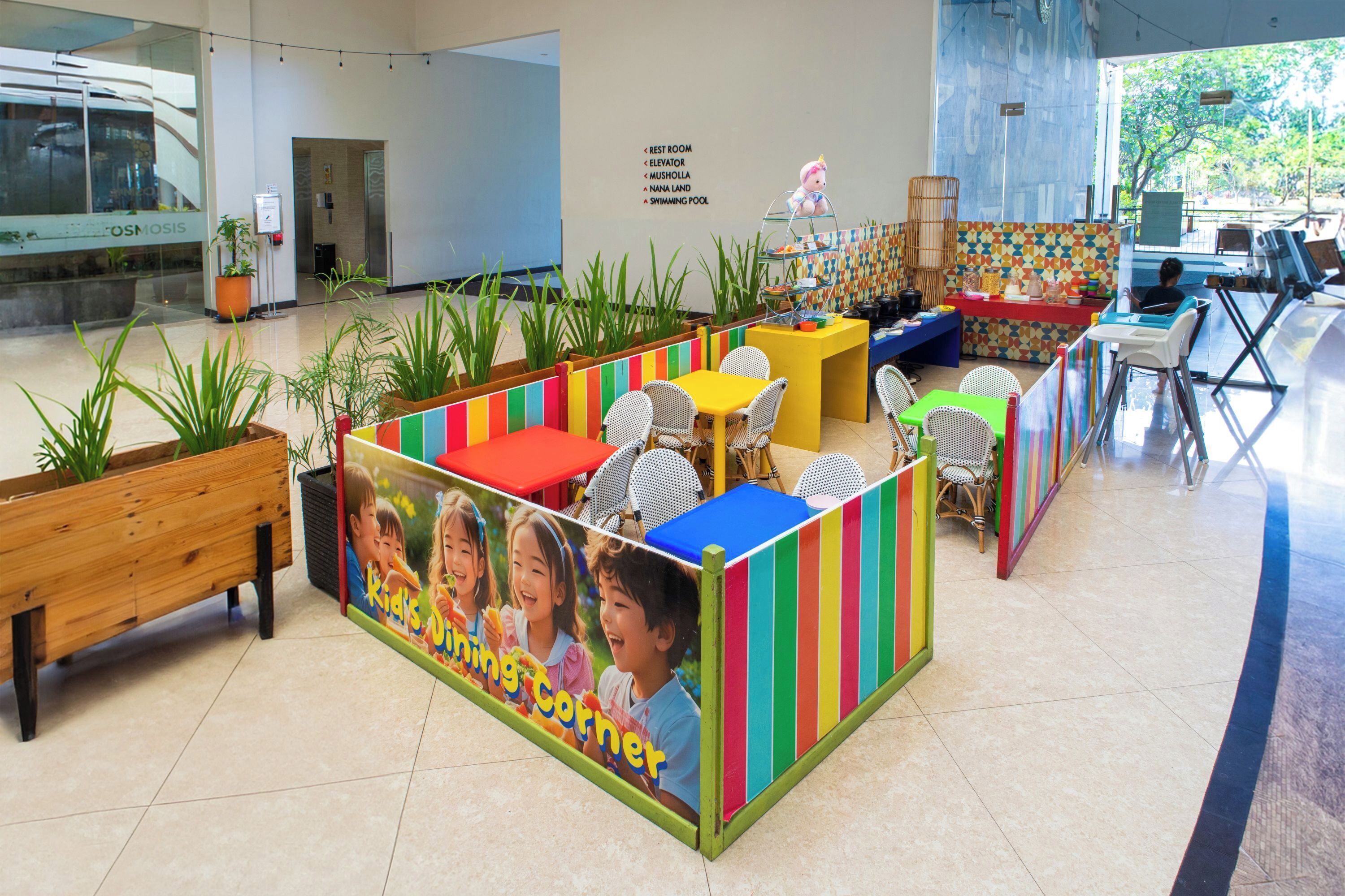 A children's play area with colorful furniture and a mural.