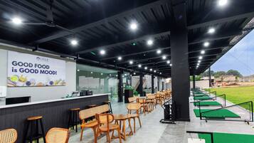 A modern indoor dining area with a counter, seating, and a sign that reads "GOOD FOOD is GOOD MOOD!"