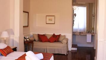 Deluxe Triple Room | Minibar, in-room safe, individually decorated, individually furnished