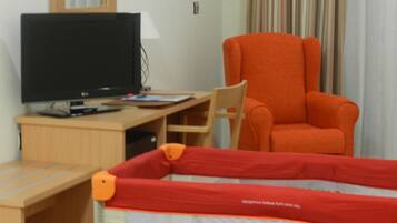Relax in this cozy space with a comfortable bed and a desk for work or leisure.