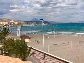 On the beach, sun-loungers, beach umbrellas, beach bar