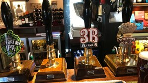 A bar area with multiple beer taps labeled with different brands and types, such as 'HOPERATION IPA' and '3B Arkell's'. - Ye Olde Red Lion (Newbury)