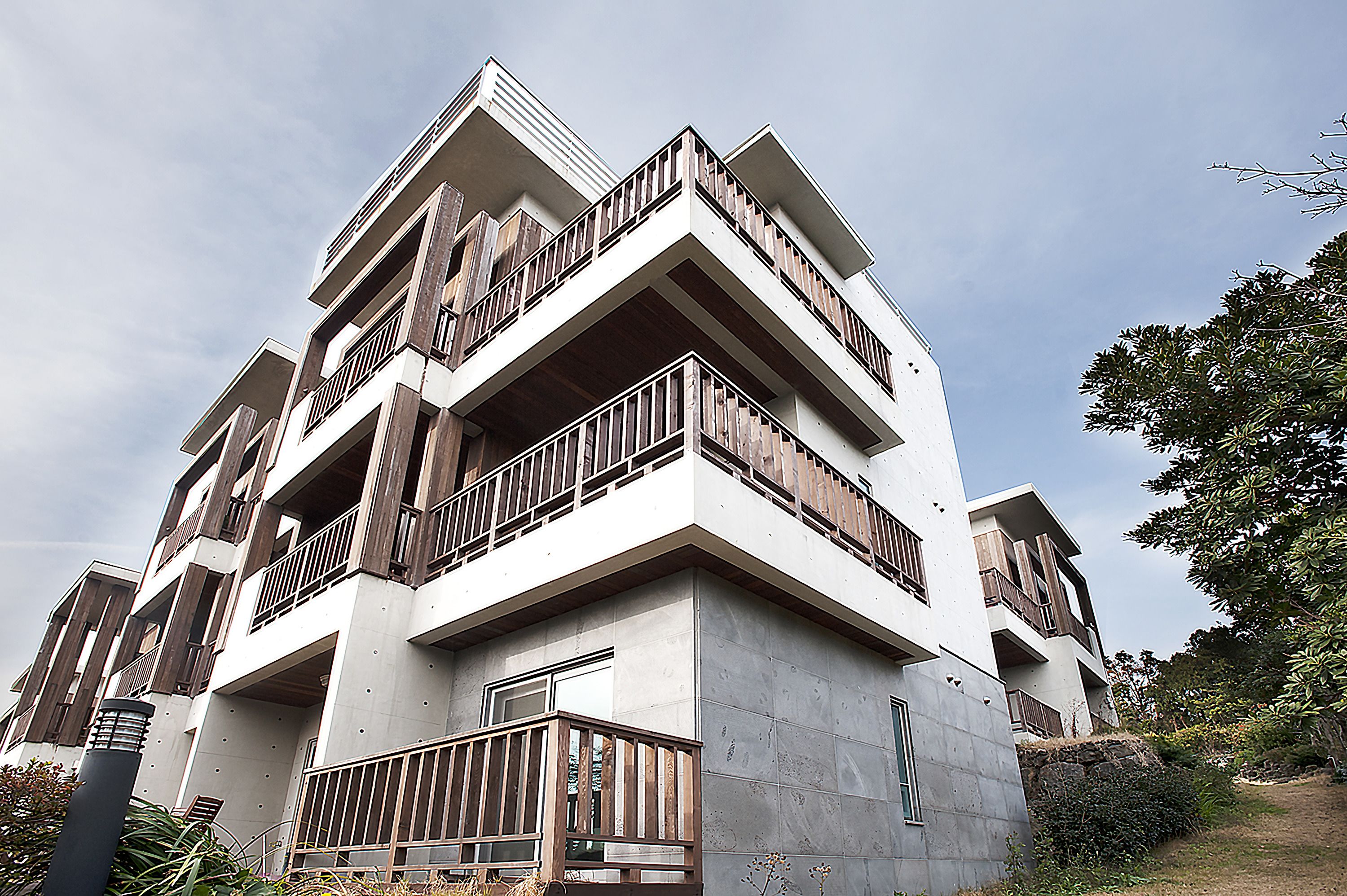 A multi-story building with balconies and a modern architectural design.