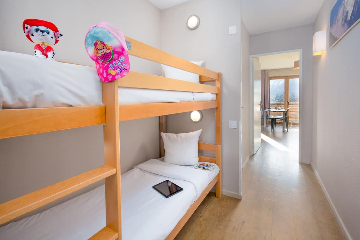 A bunk bed room with a tablet on the lower bunk.