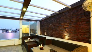 A rooftop bar with seating and a view of the cityscape. - Hotel City Star (New Delhi)
