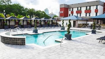 Relax by the pool surrounded by comfortable lounge chairs and lush greenery.