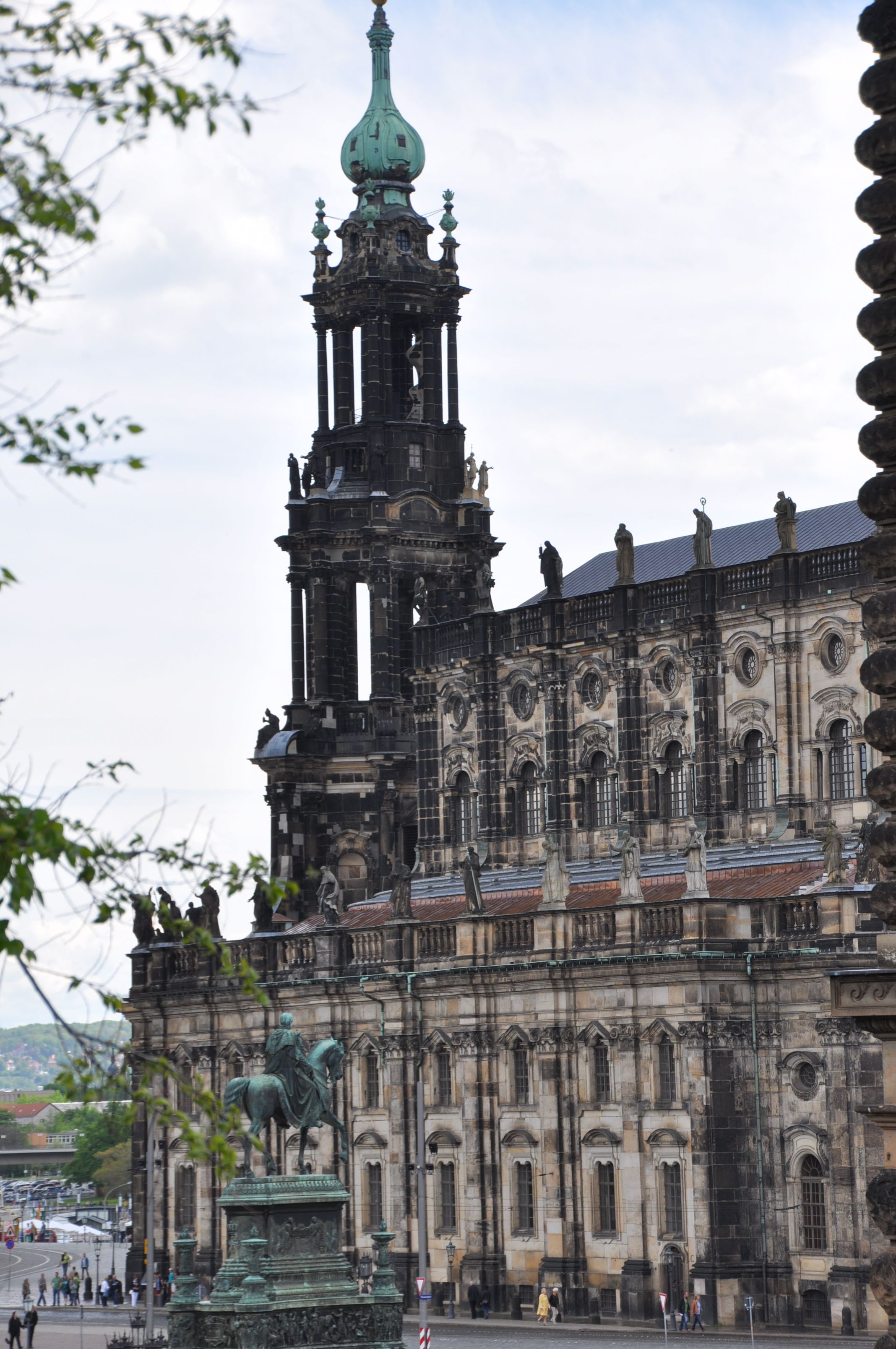 A historic building with a prominent tower and statues.