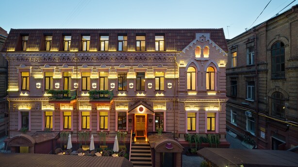 A historic building with a central entrance, multiple windows, and balconies. - Hotel 19 (Kharkiv)