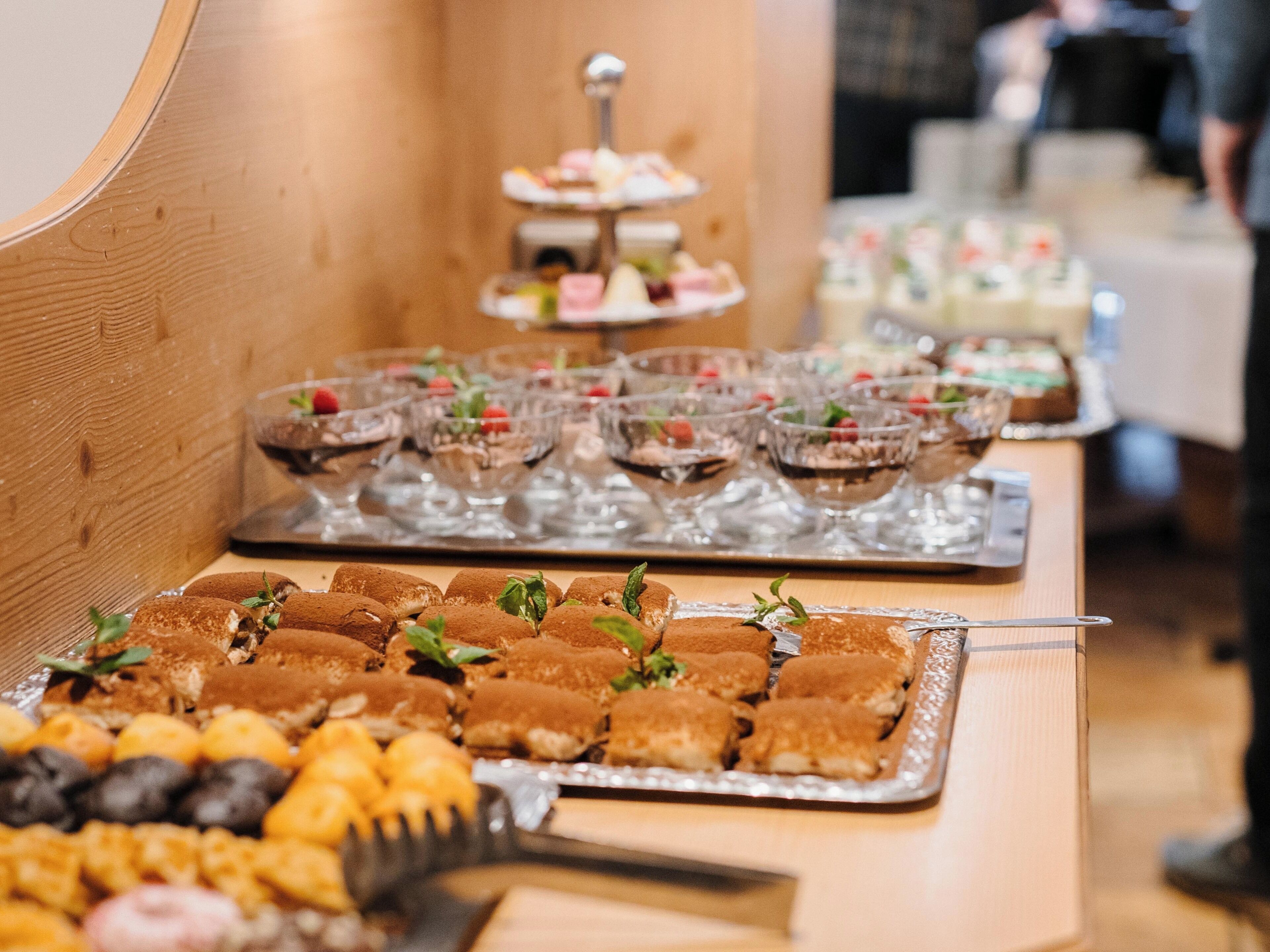 A buffet table with various desserts and pastries.