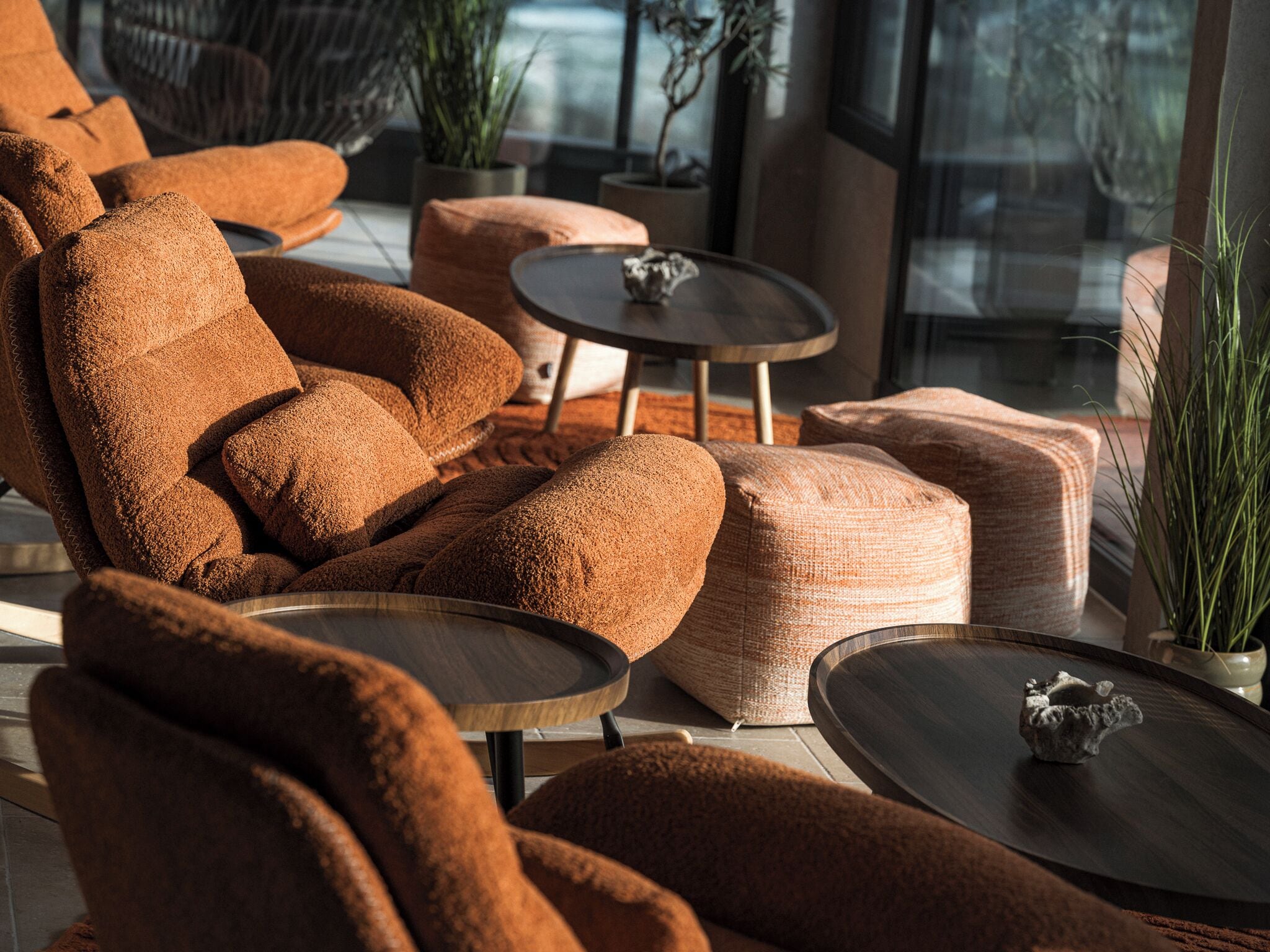 A modern living room with a brown sofa, a round coffee table, and a small decorative item on the table.