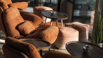 A modern living room with a brown sofa, a round coffee table, and a small decorative item on the table.
