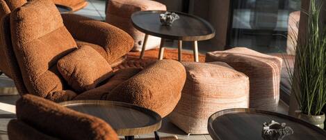 A modern living room with a brown sofa, a round coffee table, and a small decorative item on the table.